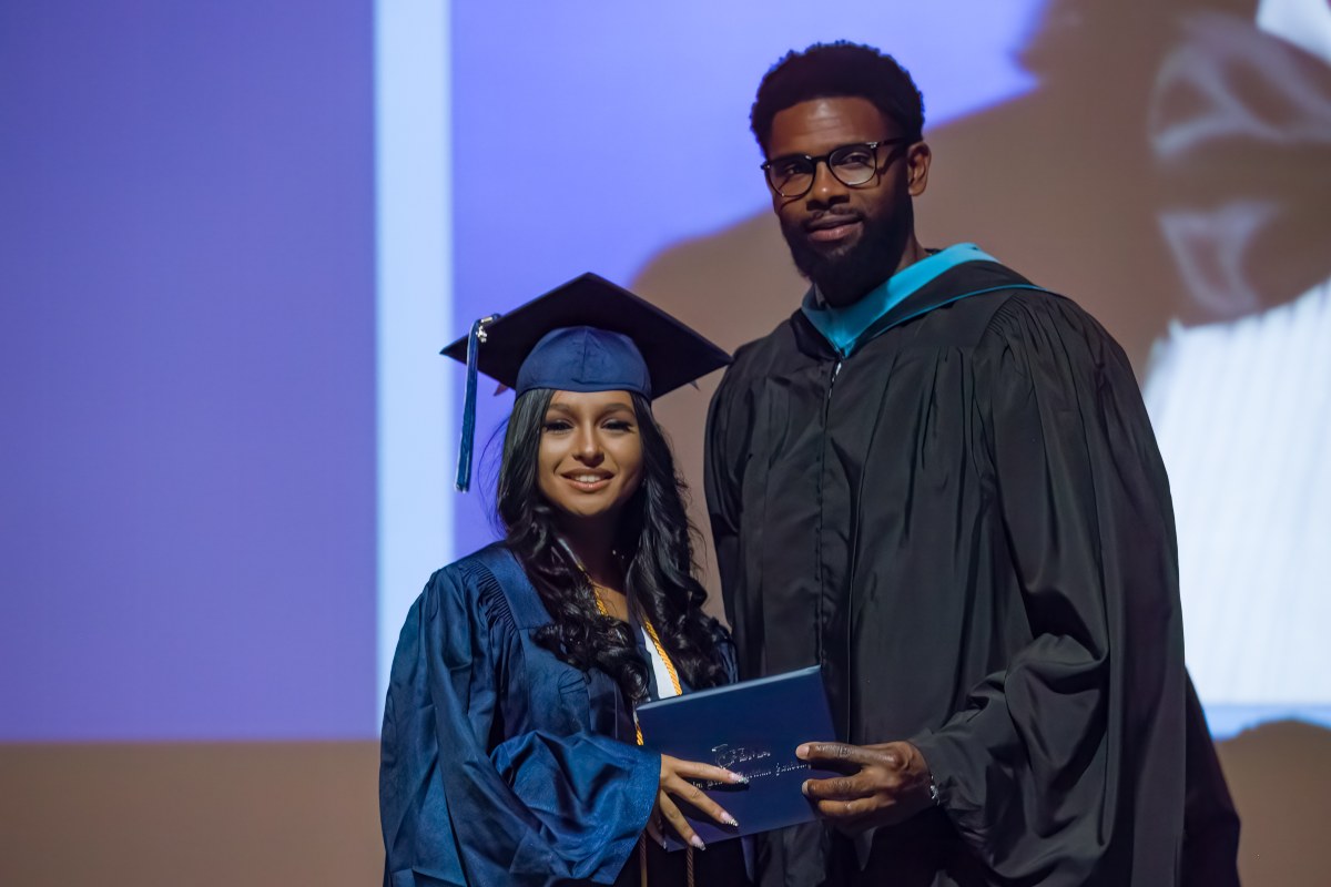 PBMA student in cap and gown at graduation ceremony
